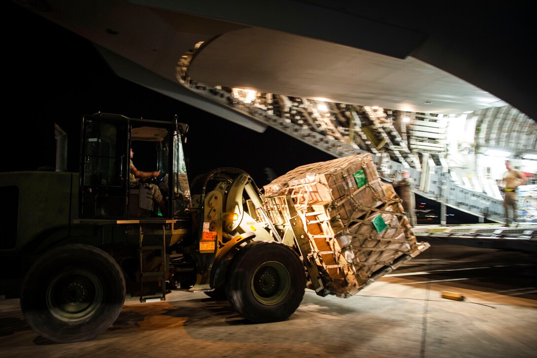 Airmen offload water and food from a C-17 Globemaster III aircraft on St. Croix.