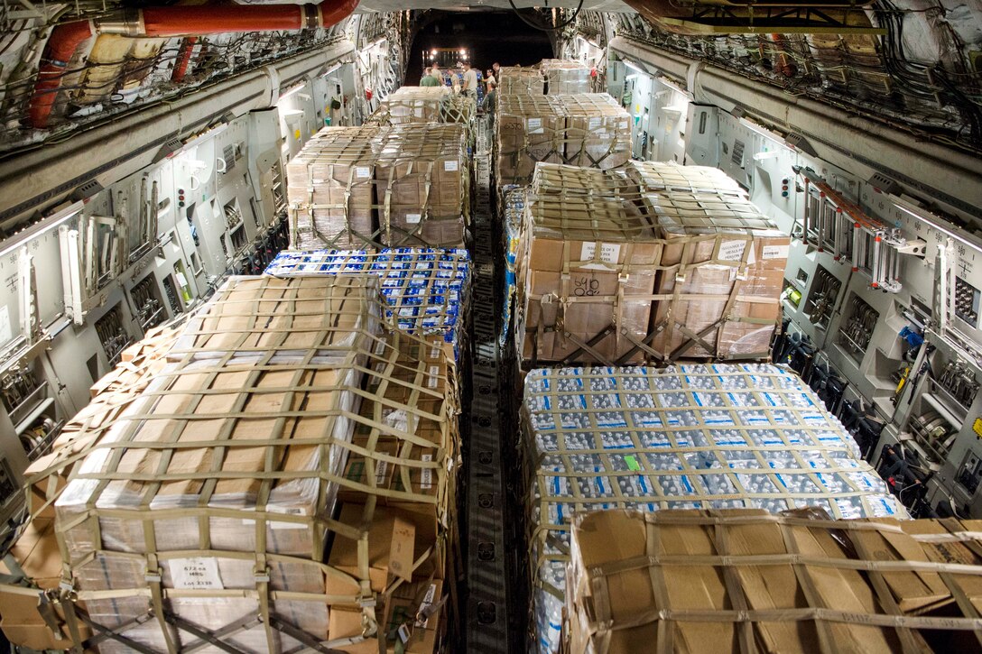 Airmen offload water and food from a C-17 Globemaster III aircraft on St. Croix.
