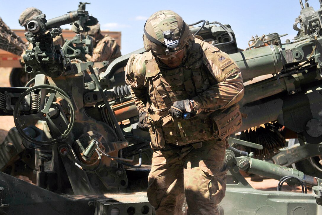 Army Pvt. Charlie Mao pulls the lanyard on a M777 howitzer during the Two Gun Raid exercise.