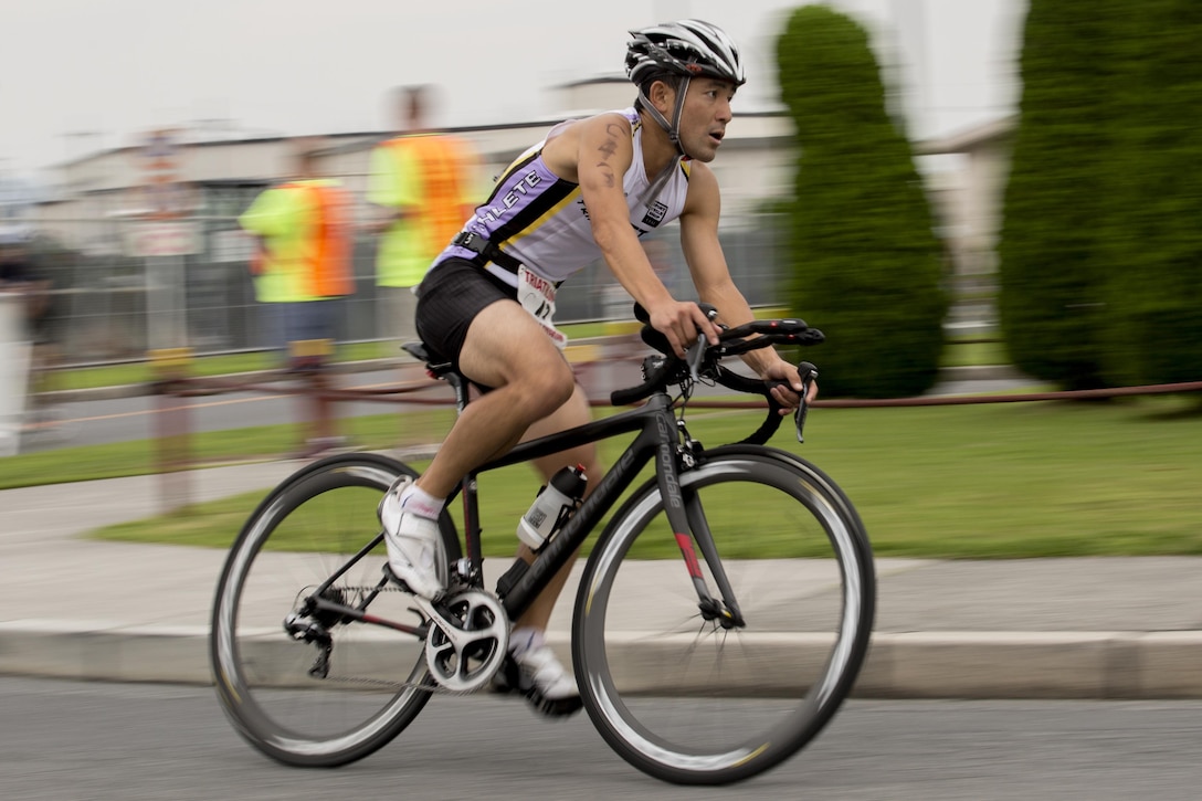 A participant in the 30th annual Marine Corps Air Station Iwakuni Triathlon hosted by Marine Corps Community Services Iwakuni, races during the 23-kilometer bicycle portion of the event at MCAS Iwakuni, Japan, Sept. 24, 2017. Marine Corps Community Services Iwakuni hosted the triathlon to energize the community and provide a positive experience through friendly competition. The event was composed of a 1-kilometer swim, a 23-kilometer bike ride and 8-kilometer run. (U.S. Marine Corps photo by Lance Cpl. Mason Roy)