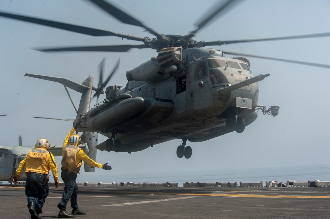 170926-N-ZS023-060 U.S. 5TH FLEET AREA OF OPERATIONS (Sept. 26, 2017) A CH-53E Super Stallion helicopter assigned to Marine Medium Tiltrotor Squadron (VMM) 161 (Reinforced) lifts off from the flight deck of the amphibious assault ship USS America (LHA 6). America is the flagship for the America Amphibious Ready Group and, with the embarked 15th Marine Expeditionary Unit, is deployed to the U.S. 5th Fleet area of operations in support of maritime security operations to reassure allies and partners and preserve the freedom of navigation and the free flow of commerce in the region. (U.S. Navy photo by Mass Communication Specialist Seaman Vance Hand/Released)
