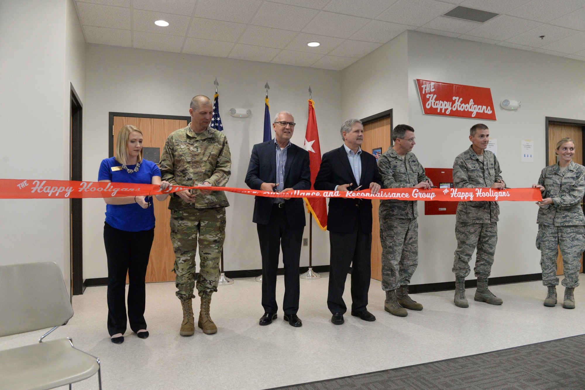 From left to right Megan Edwardson, Representative for Senator Heitkamp, Maj. Gen. Al Dohrmann, the N.D. Adjutant General, Kevin Cramer, US Congressman, Sen. John Hoeven, Col. Britt Hatley, the 119th Wing commander,
Col Darrin Anderson, the 119th Intelligence, Surveillance and Reconnaissance (ISRG) Group commander, and Staff Sgt. Tracy Woodbury prepare to cut a symbolic ribbon at a building dedication ceremony for the new ISRG building
at the North Dakota Air National Guard Base, Fargo, N.D., Sept. 22, 2017