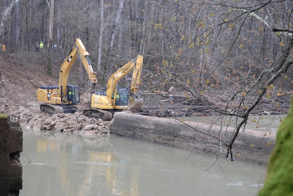 The excavators break up Dam No. 6 while building a work pad from which to remove material during the demolition, which was completed in April.