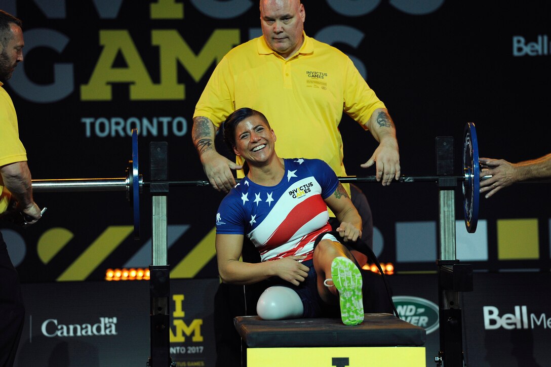 Air Force Staff Sgt. Sebastiana Lopez-Arellano celebrates her victory in the lightweight powerlifting competition.