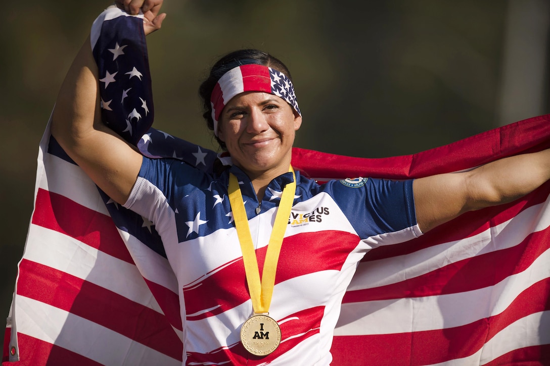 Air Force Staff Sgt. Sebastiana Lopez-Arellano celebrates to winning a gold medal in the hand cycling.