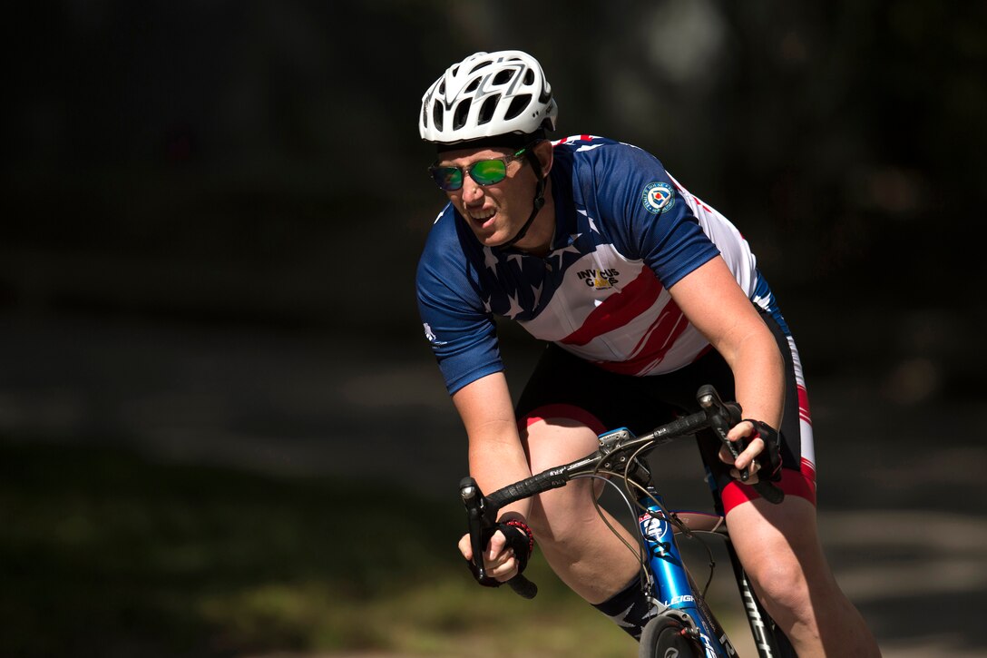 Air Force Captain Cal Gentry races a bicycle during Invictus Games 2017.