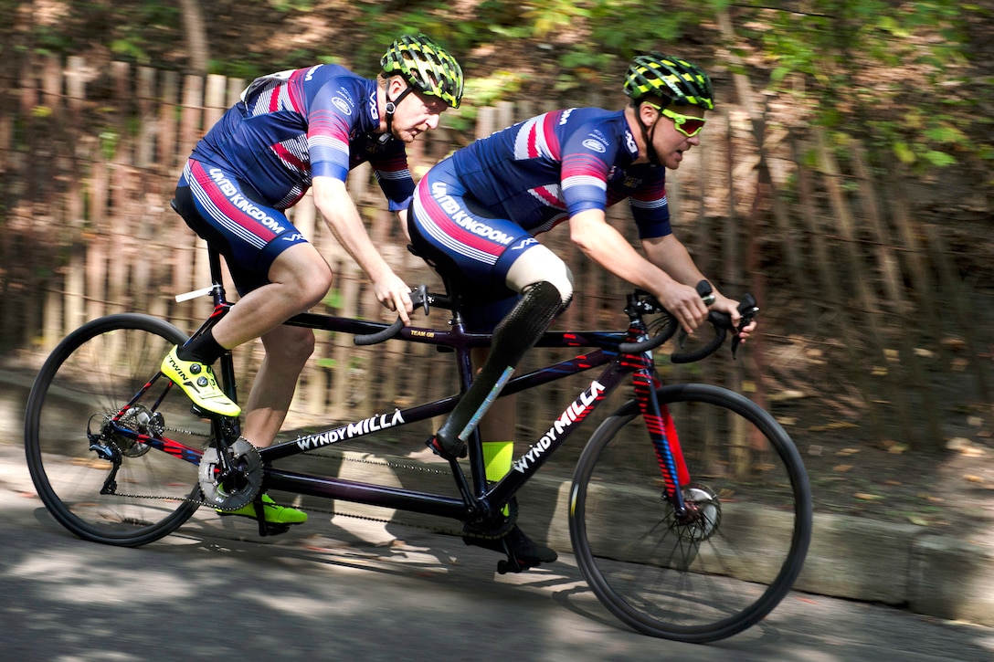 Visually impaired cyclist Jamie Weller of Team Great Britain races a tandem bicycle with the help of a guide.