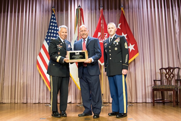 Lt. Gen. Todd T. Semonite, chief of engineers and commanding general of the U.S. Army Corps of Engineers, and USACE Command Sgt. Maj. Bradley Houston, present the USACE Engineer of the Year award to David Kiefer at the National Awards Ceremony in Washington, D.C., Aug. 2, 2017.