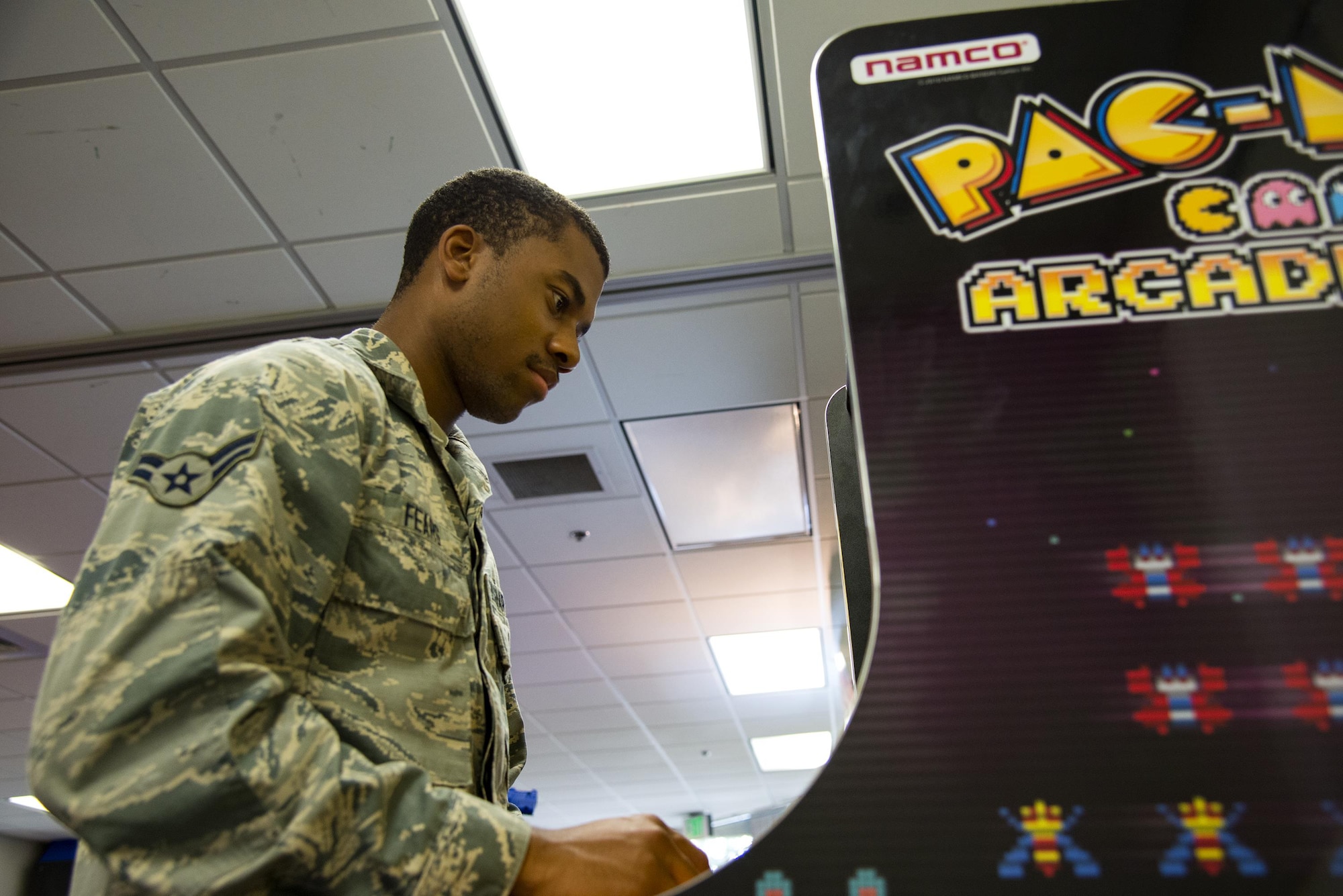 Airman 1st Class Keven Fears, 23d Force Support Squadron services specialist, plays an arcade game, Sept. 15, 2017, at Moody Air Force Base, Ga. The 23d Civil Engineer Squadron dorm management office is revamping the day rooms to help foster better wingmanship and morale among Airmen living in the dorms. (U.S. Air Force photo by Airman 1st Class Erick Requadt)