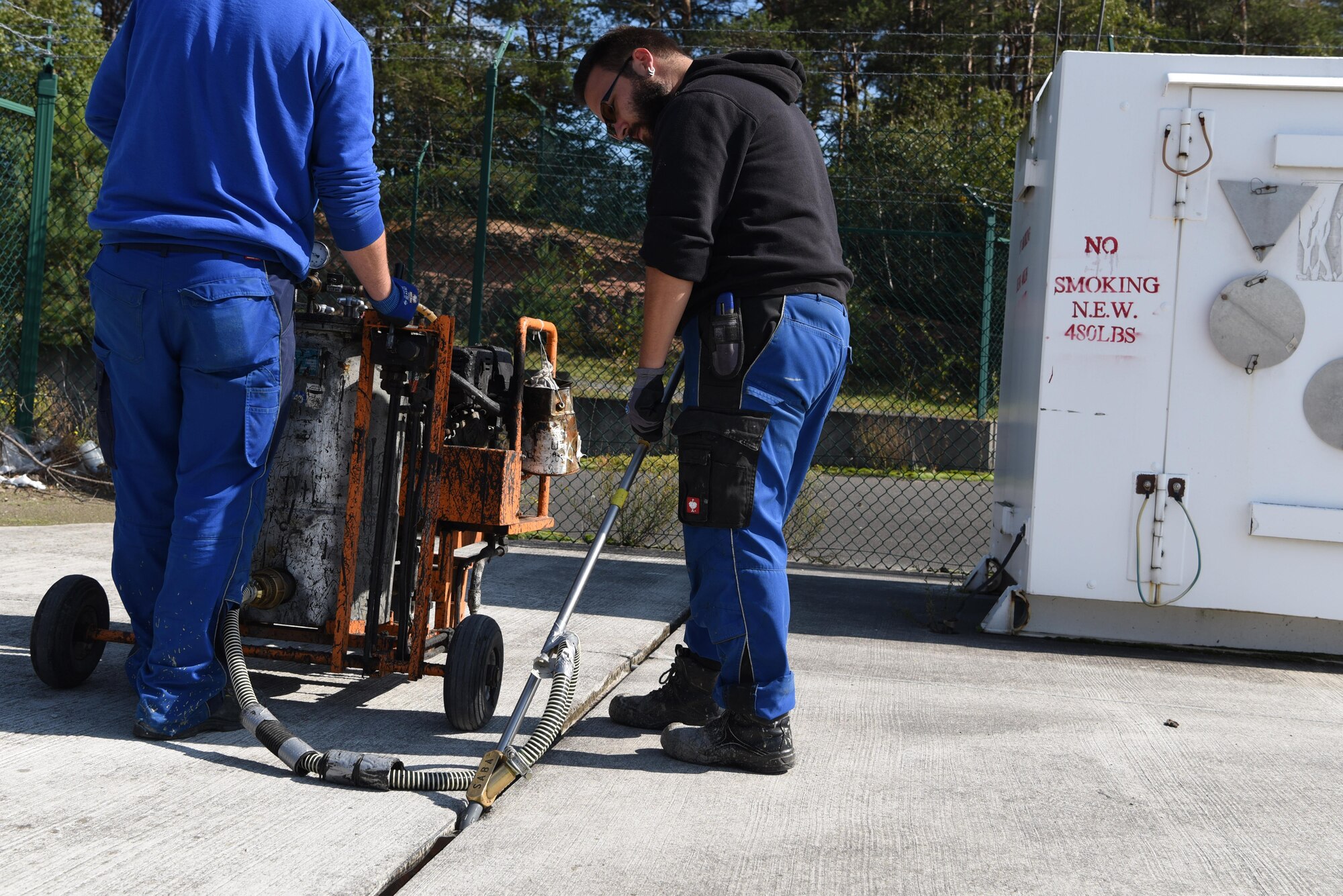Ronny, a German contractor, adjusts his tools to inject tar in the drains of Ramp 5 on Ramstein Air Base, Germany Sept 21, 2017. The new tar being applied should allow for the drains to be fully functional for years. (U.S. Air Force photo by Airman 1st Class Milton Jr. Hamilton)