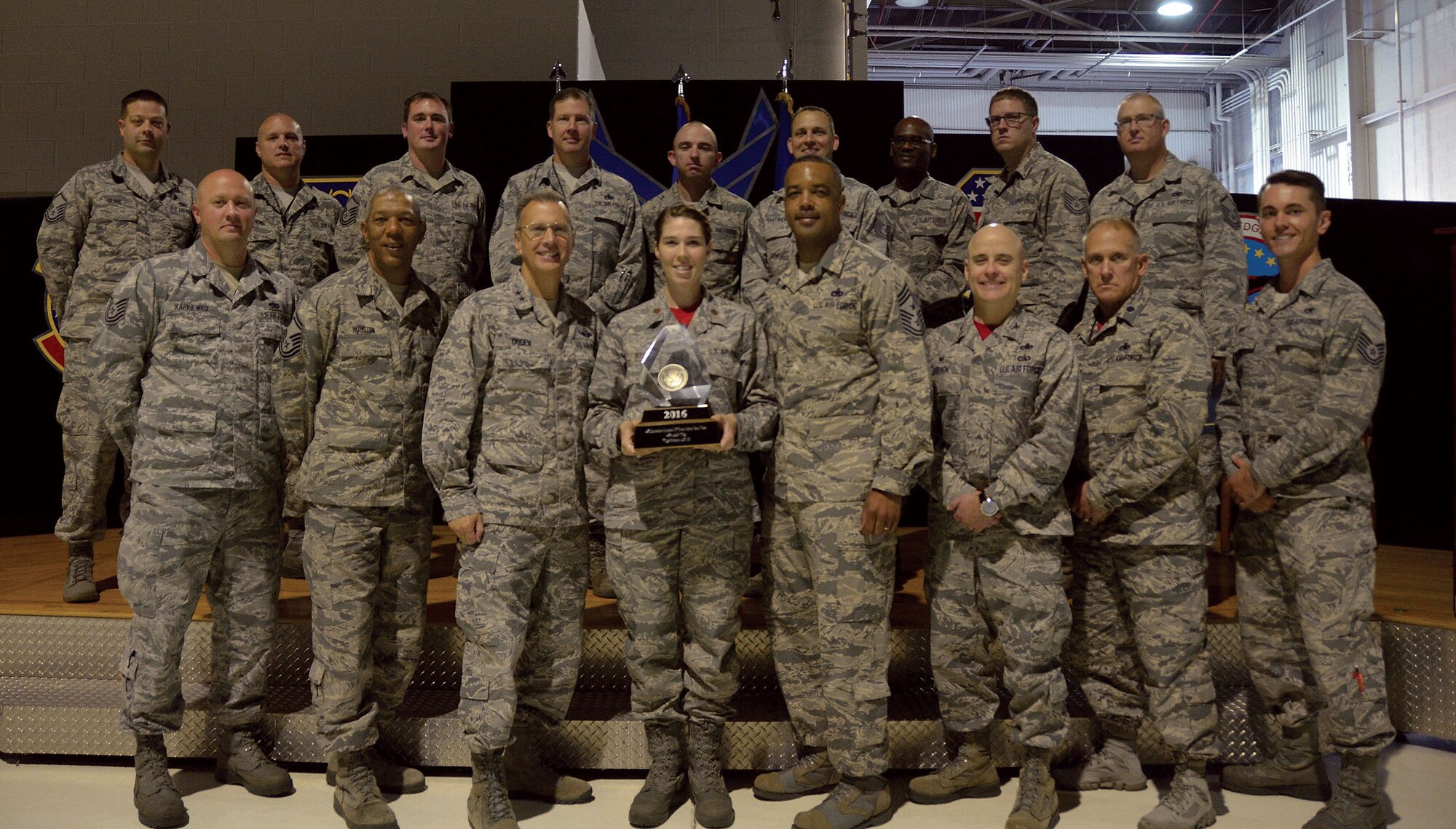 Maj. Gen. Randall Ogden and Chief Master Sgt. Timothy White, 4th Air Force commander and command chief, present the Chief of Staff Team Excellence Award trophy to members of the 445th Maintenance Squadron Sept. 9, 2017. (U.S. Air Force photo/Staff Sgt. Joel McCullough)