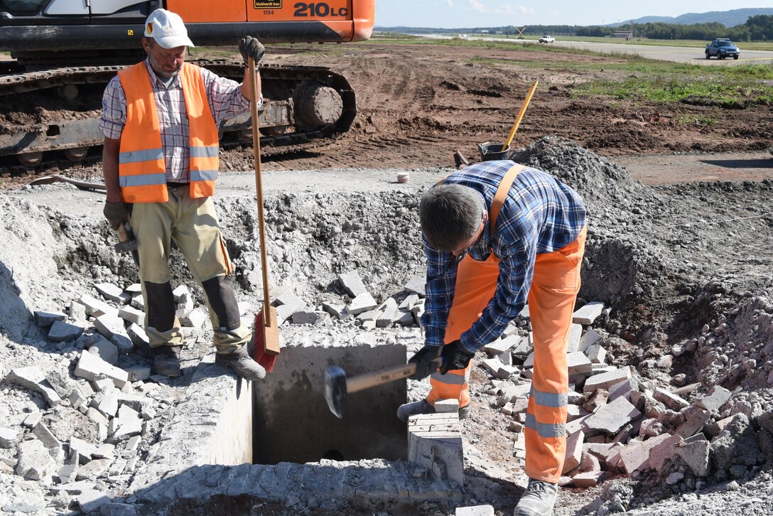Wislaw and Dirk, German contract workers, lay the foundation for the new infield drainage project on the flightline on Ramstein Air Base, Germany Sept. 21, 2017. Wislaw and Dirk were part of a six man team working on the initial phase of the project. (U.S. Air Force photo by Airman 1st Class Milton Jr. Hamilton)
