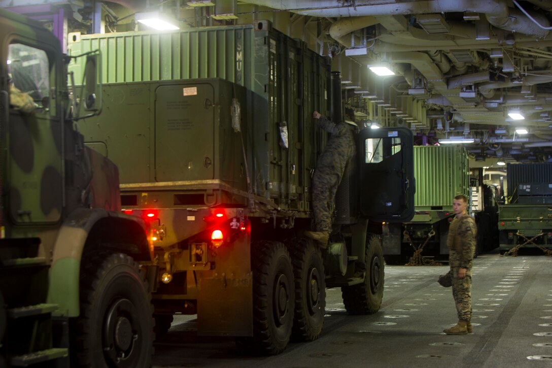 U.S Marines with the 26th Marine Expeditionary Unit (MEU) inspect equipment tied to a Medium Tactical Vehicle Replacement aboard the amphibious assault ship USS Kearsarge (LHD 3) in the Caribbean Sea, Sept. 26, 2017.  The 26th MEU is supporting Federal Emergency Management Agency (FEMA), the lead federal agency, in helping those affected by Hurricane Maria to minimize suffering and is one component of the overall whole-of-government response effort. (U.S. Marine Corps photo by Cpl. Juan A. Soto-Delgado)