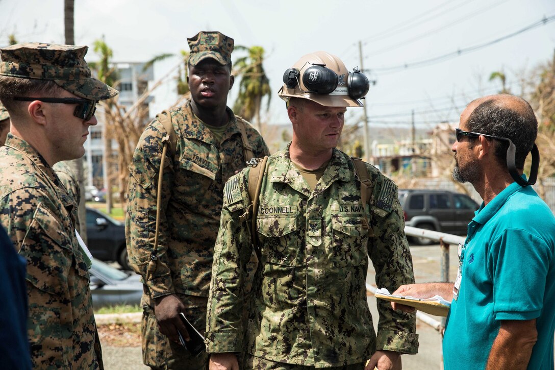 U.S. Navy Petty Officer 2nd Class John McConnell, center, a construction mechanic assigned to the amphibious assault ship USS Kearsarge (LHD 3), talks with a civilian employee after repairing a Hima San Pablo Hospital generator relief efforts for victims of Hurricane Maria in Ceiba, Puerto Rico, Sept. 26, 2017. The 26th MEU is supporting the Federal Emergency Management Agency, the lead federal agency, and local authorities in Puerto Rico and the U.S. Virgin Islands with the combined goal of protecting the lives and safety of those in affected areas. (U.S. Marine Corps photo by Lance Cpl. Tojyea G. Matally)