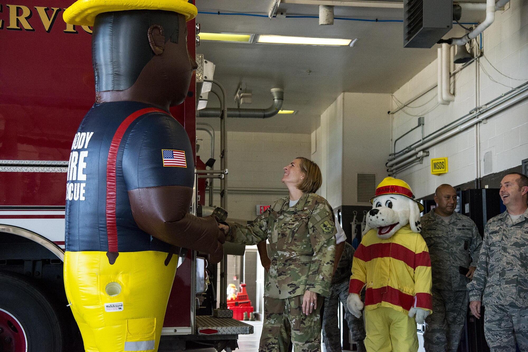 Col. Jennifer Short, 23d Wing commander, shakes hands with 23d Civil Engineer Squadron mascot, Fireman Fred, Sept. 25, 2017, at Moody Air Force Base, Ga. Short proclaimed the week of Oct. 8-14 as Fire Prevention Week, which is designed to commemorate the sacrifices of our firefighters and teach fire safety to others. (U.S. Air Force photo by Airman 1st Class Erick Requadt)