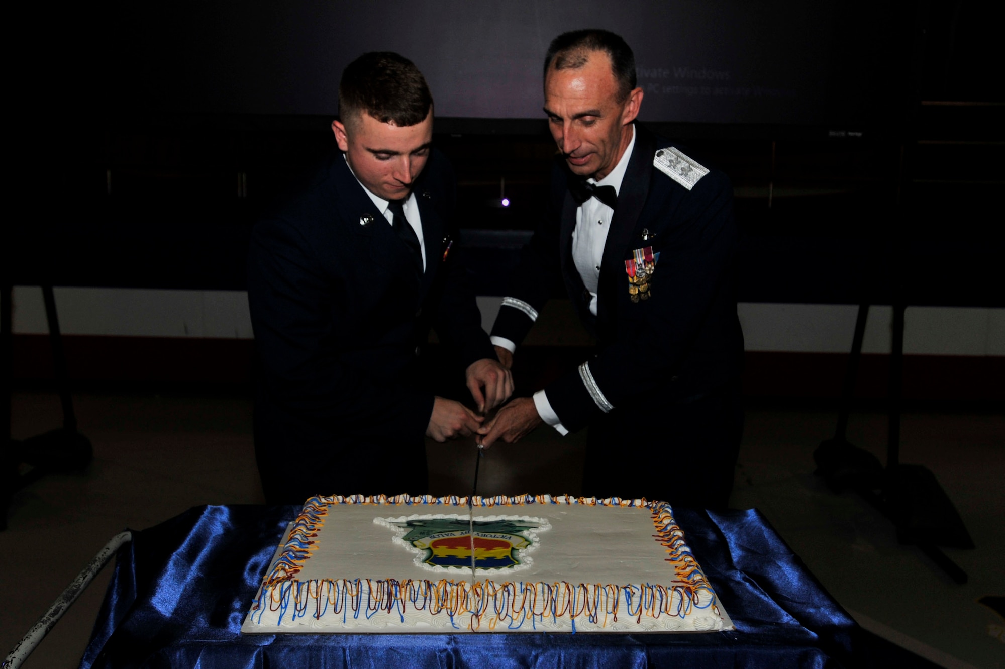 As a time-honored Air Force tradition, the most senior and youngest Airmen on station cut the Air Force Ball cake together.