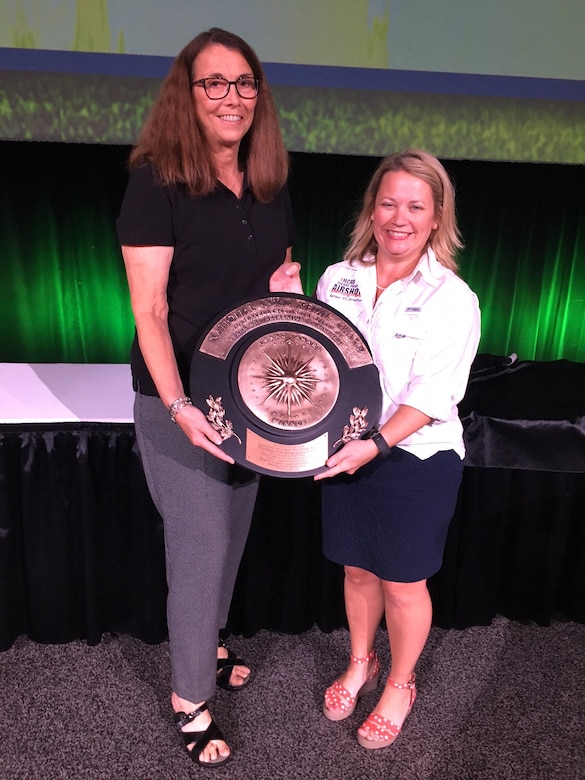 Vera Campbell, director of Marine and Family Programs, and Kimberly Johnston, director of Semper Fit, accept the Armed Forces Recreation Gold Medal Award.