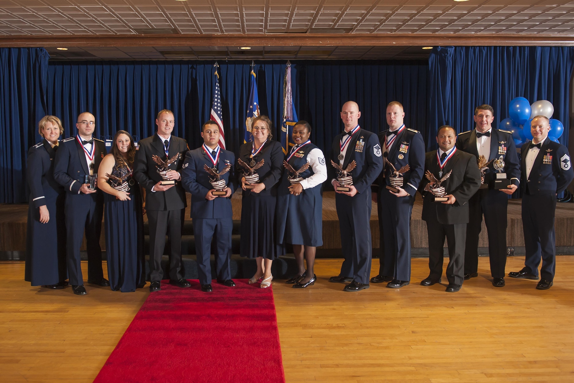 Col. DeAnna Burt (left), former 50th Space Wing commander, and Chief Master Sgt. David Pesch (right), then 50 SW command chief, honor 50 SW annual award winners after the 2016 50 SW Annual Awards Banquet at the Club on Peterson Air Force Base, Colorado, Thursday, Feb. 9, 2017.