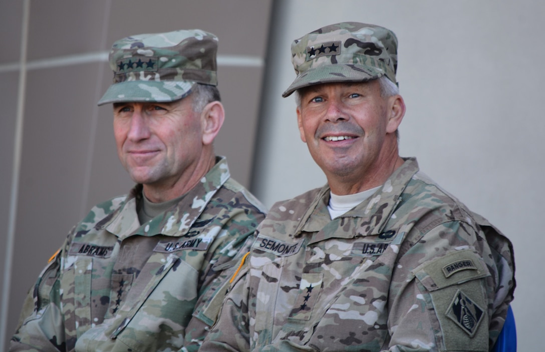 Gen. Robert Abrams, commanding general, U.S. Army Forces Command, left, and Lt. Gen. Todd Semonite, commanding general, U.S. Army Corps of Engineers, right, look out into the audience during a Sept. 21 ribbon-cutting ceremony for the new Weed Army Community Hospital at Fort Irwin, California.