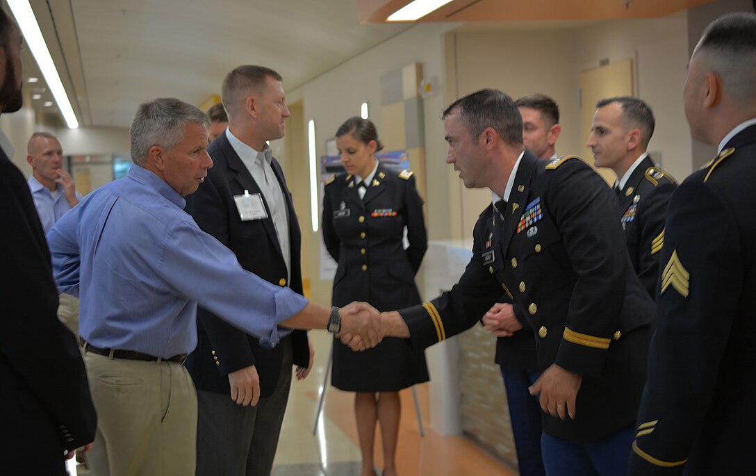 Lt. Gen. Todd Semonite, commanding general, U.S. Army Corps of Engineers, left, and Maj. Gen. Thomas Tempel Jr., commanding general, Regional Health Command-Central, second from left, greet Soldiers during a Sept. 20 tour of the new Weed Army Community Hospital at Fort Irwin, California.