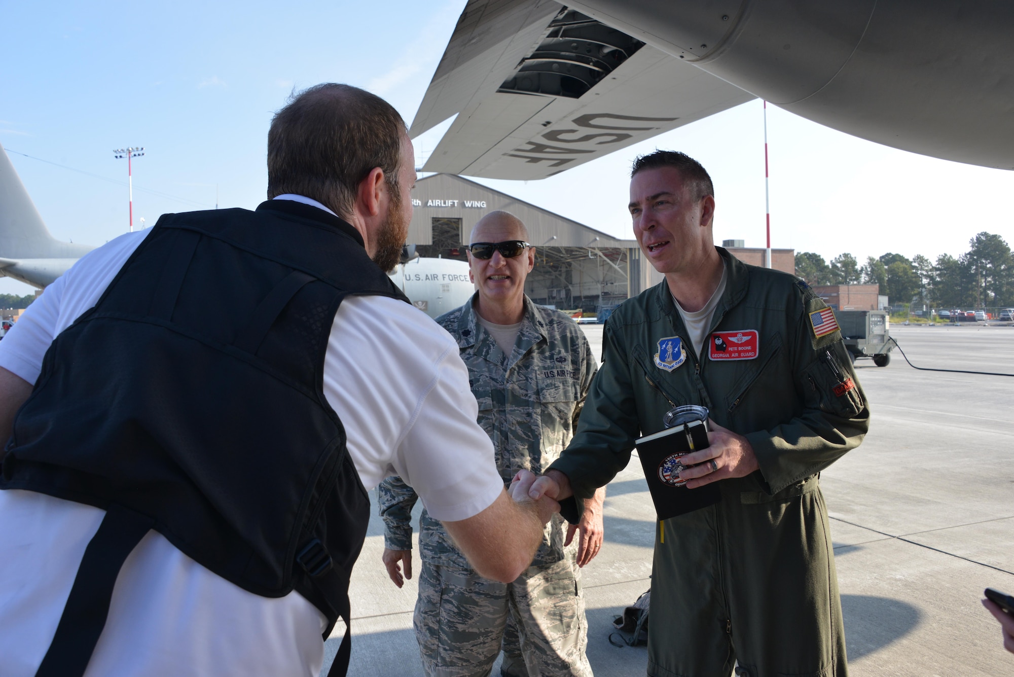Col. Peter Boone, Air Commander of the 165th Airlift Wing, greets WTOC videographer Sean Evans before a C-130H aircraft departs Savannah to deliver supplies to St. Thomas, Virgin Islands Sept. 22, 2017. Evans is traveling along with a media team covering hurricane relief efforts on the ravaged Caribbean island. (U.S. Air National Guard photo by Staff Sgt. Chelsea Smith)