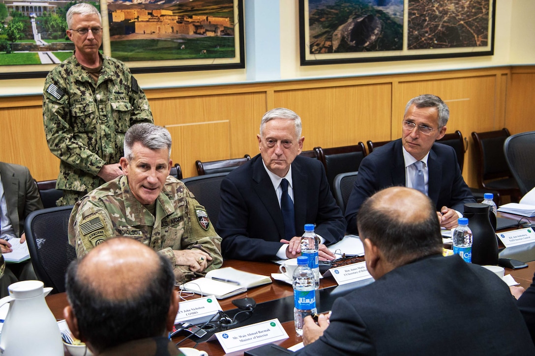 Defense and military leaders attend a meeting.