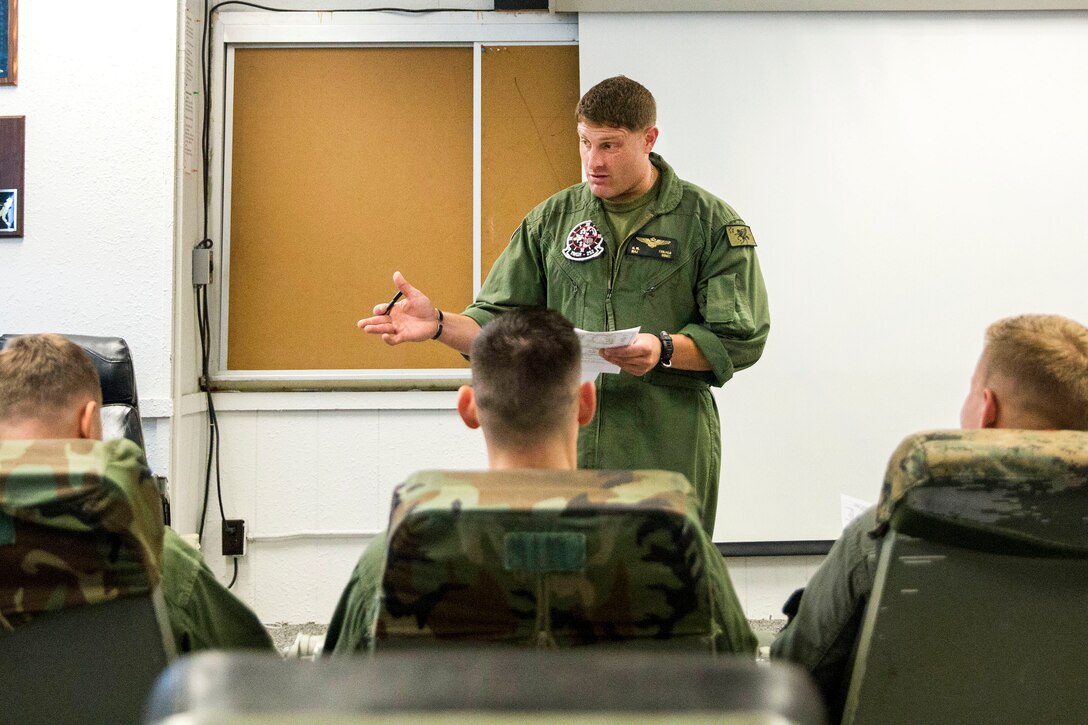 Maj. Nick M. Culver briefs pilots before conducting an aerial refueling training.