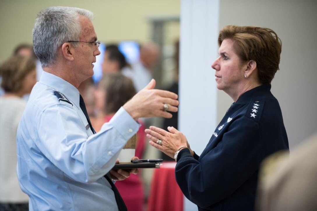 Air Force Gen. Lori Robinson speaks with Air Force Gen Paul Selva during a meeting at Andrews Air Force Base.