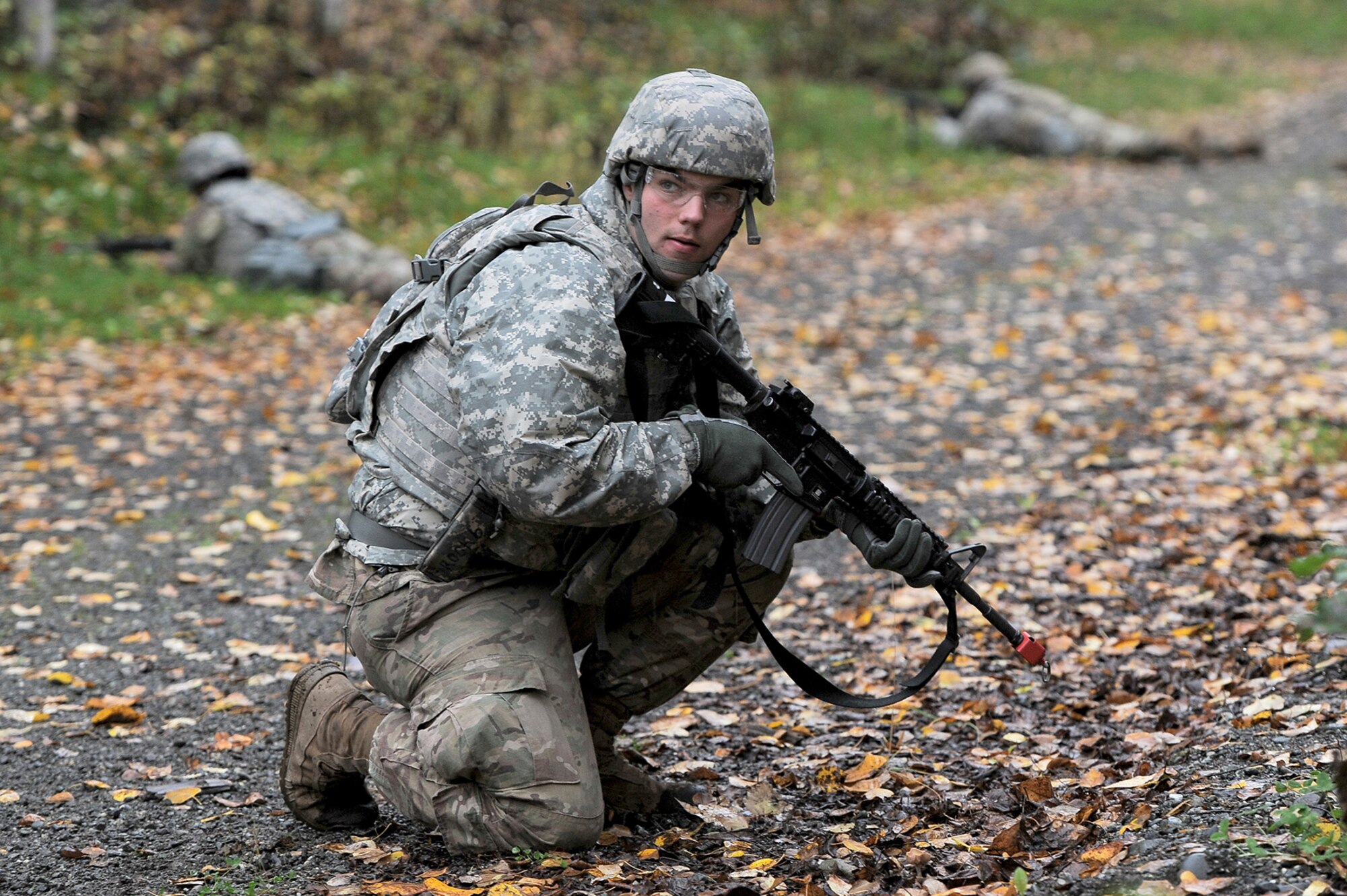 A soldier assigned to the 109th Transportation Company "Muleskinners", 17th Combat Sustainment Support Battalion, U.S. Army Alaska, watches his sector of fire as fellow Soldiers react to contact during an exercise on Joint Base Elmendorf-Richardson, Alaska, Sept. 21, 2017.  The Soldiers performed this training as part of a larger exercise in multiple locations to build and maintain proficiency in essential soldiering skills like react to contact, and securing an objective as well as traffic control point training.