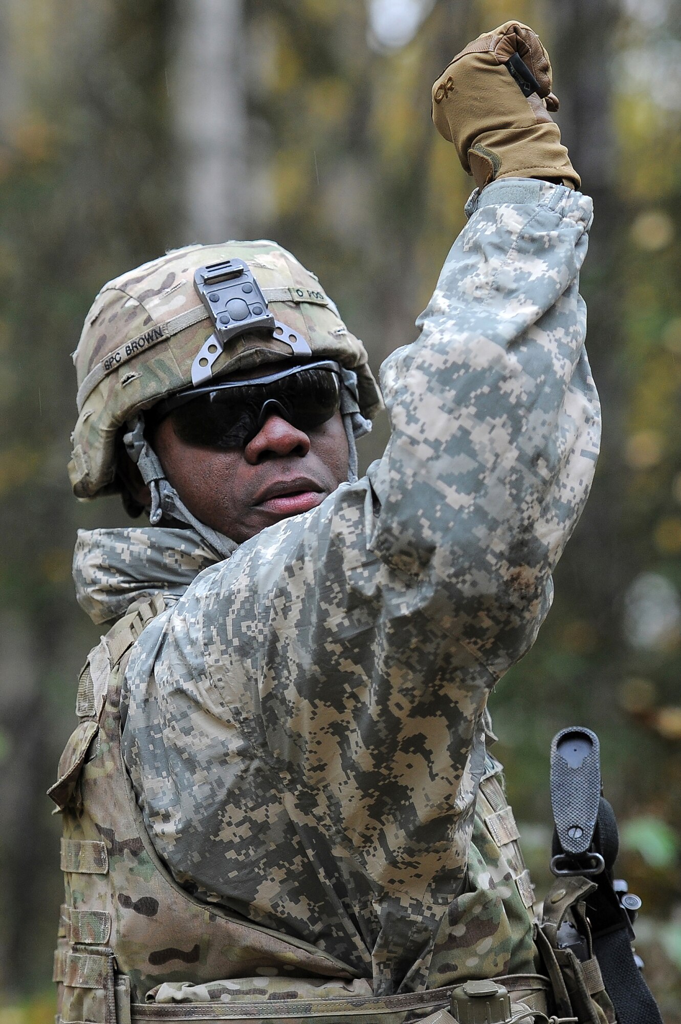 Spc. Stephen Brown, assigned to the 109th Transportation Company "Muleskinners", 17th Combat Sustainment Support Battalion, U.S. Army Alaska, signals to fellow Soldiers during a tactical movement during an exercise on Joint Base Elmendorf-Richardson, Alaska, Sept. 21, 2017.  The Soldiers performed react to contact, and securing an objective as well as traffic control point training as part of a larger exercise in multiple locations to build and maintain proficiency in essential soldiering skills.