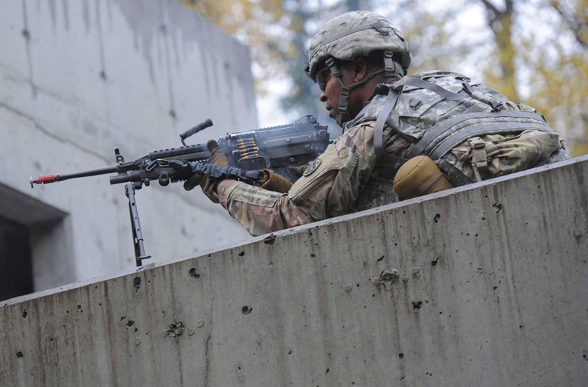 A soldier assigned to the 109th Transportation Company "Muleskinners", 17th Combat Sustainment Support Battalion, U.S. Army Alaska, provides suppresive fire for fellow Soldiers as they assault an objective during an exercise on Joint Base Elmendorf-Richardson, Alaska, Sept. 21, 2017.  The Soldiers performed this training as part of a larger exercise in multiple locations to build and maintain proficiency in essential soldiering skills like react to contact, and securing an objective as well as traffic control point training.
