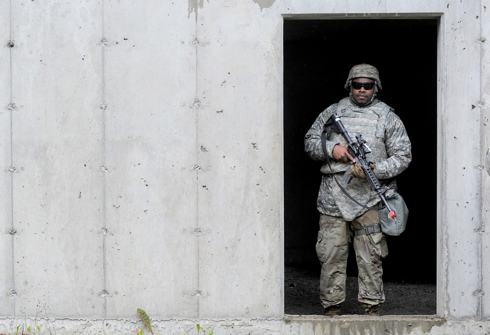 Army Staff Sgt. Willie Kelly, assigned to the 109th Transportation Company "Muleskinners", 17th Combat Sustainment Support Battalion, U.S. Army Alaska, stands in the doorway of a building in a mock village after an exercise on Joint Base Elmendorf-Richardson, Alaska, Sept. 21, 2017.  The Soldiers performed this training as part of a larger exercise in multiple locations to build and maintain proficiency in essential soldiering skills like react to contact, and securing an objective as well as traffic control point training.