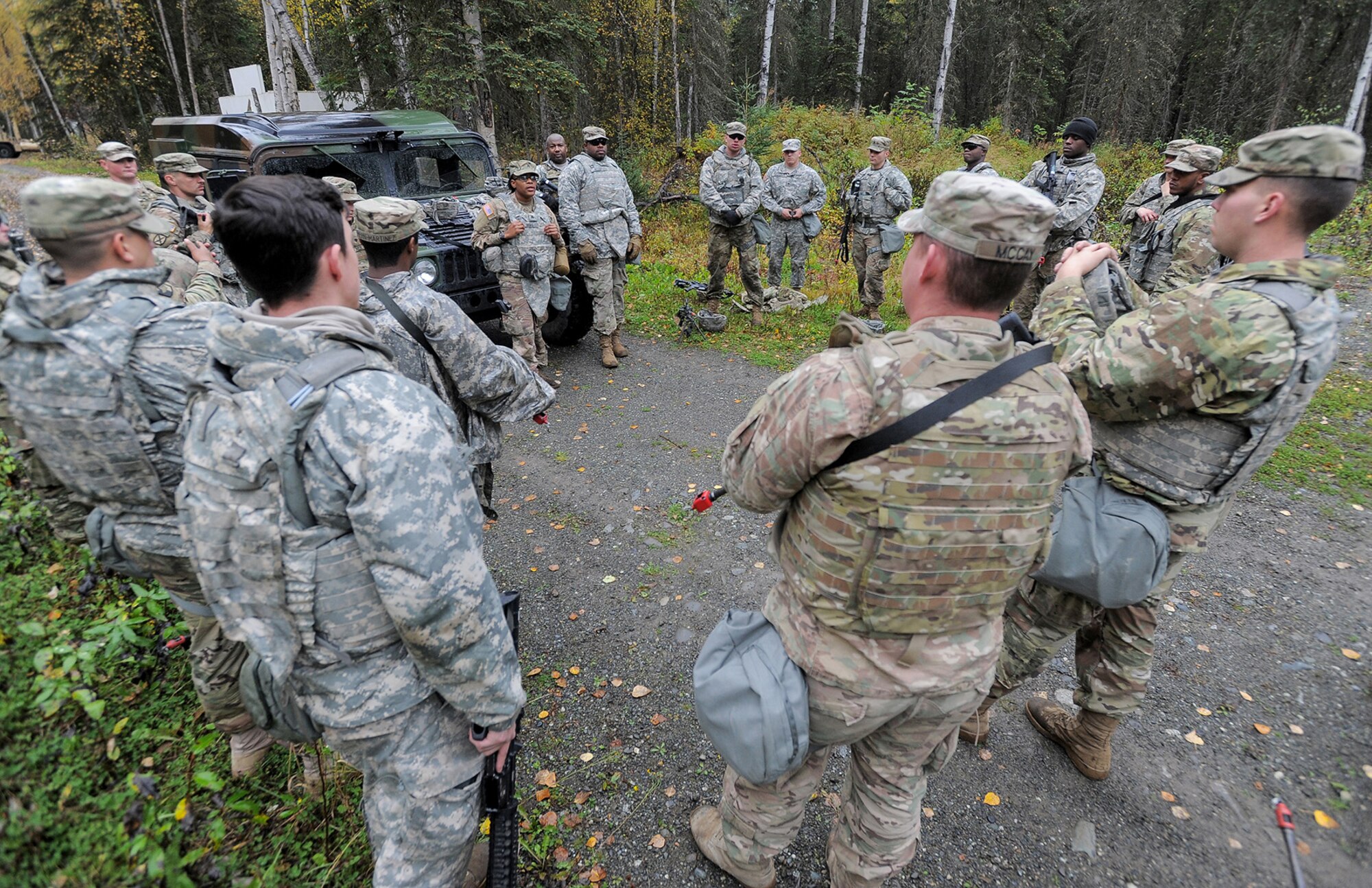 Soldiers assigned to the 109th Transportation Company "Muleskinners", 17th Combat Sustainment Support Battalion, U.S. Army Alaska, conduct an after-action review with Army Sgt. Shatavia Deas, center, following an exercise on Joint Base Elmendorf-Richardson, Alaska, Sept. 21, 2017.  The Soldiers performed this training as part of a larger exercise in multiple locations to build and maintain proficiency in essential soldiering skills like react to contact, and securing an objective as well as traffic control point training.