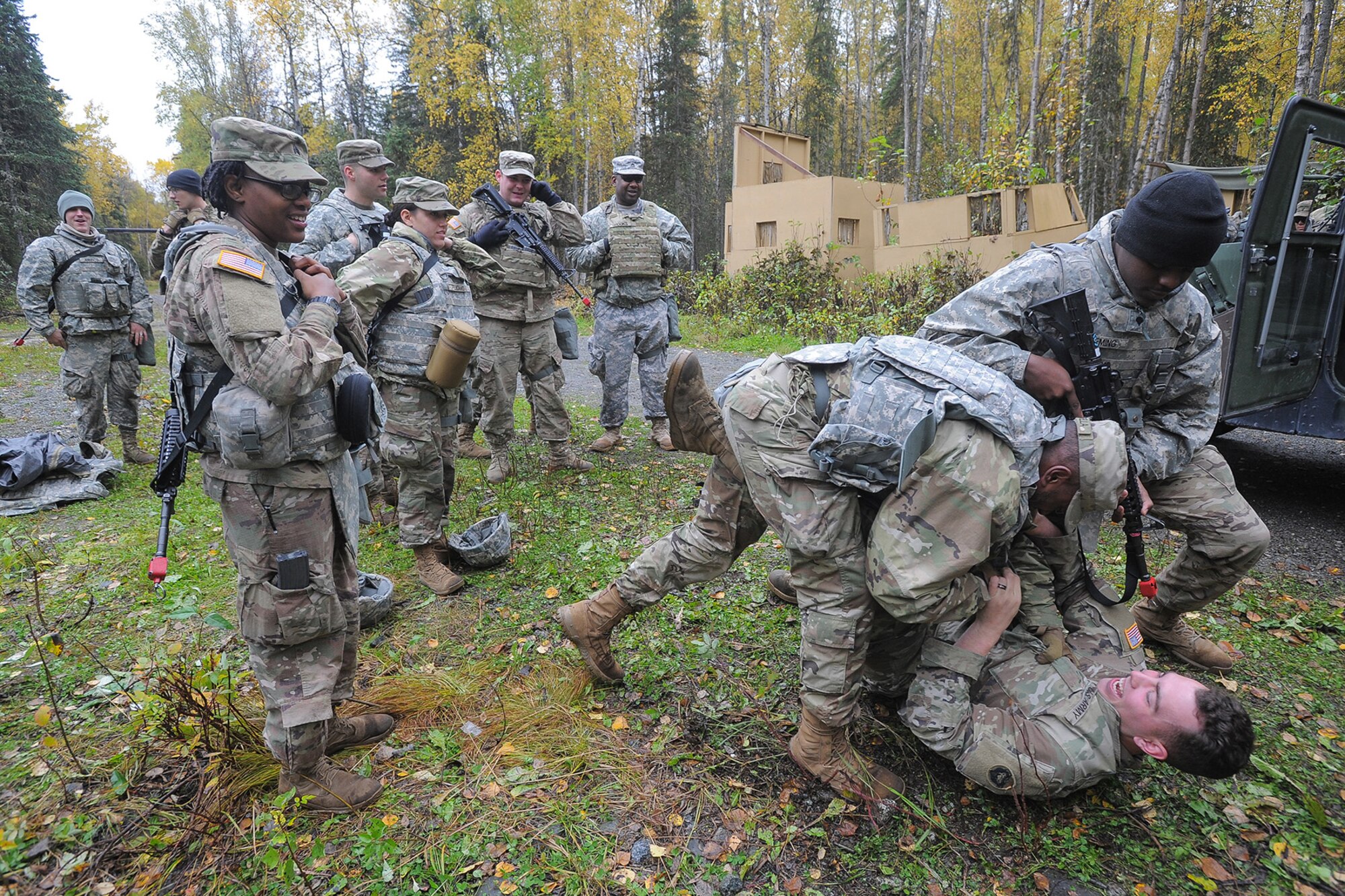 Army Pfc. Nathaniel Estrella, and Spc. Larry Fleming, both assigned to the 109th Transportation Company "Muleskinners", 17th Combat Sustainment Support Battalion, U.S. Army Alaska, grapple with a soldier role-playing as an insurgent during traffic control point training on Joint Base Elmendorf-Richardson, Alaska, Sept. 21, 2017.  The Soldiers performed this training as part of a larger exercise in multiple locations to build, and maintain proficiency in essential soldiering skills.