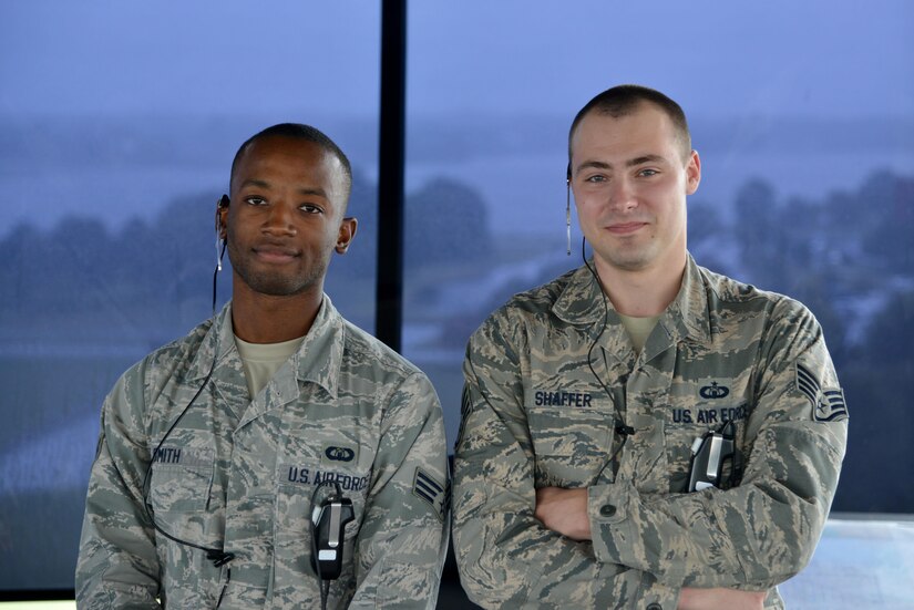 (From left) U.S. Air Force Senior Airman Richard Smith, 1st Operation Support Squadron air traffic controller, and Staff Sgt. Joshua Shaffer, 1st OSS tower watch supervisor pose for a photo at Joint Base Langley-Eustis, Va., Sept. 26, 2017.