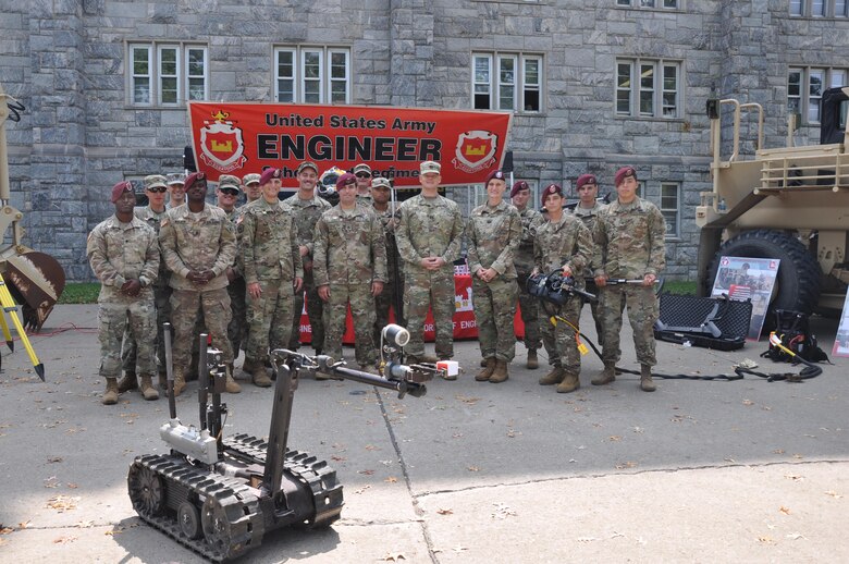 Soldiers from the 20th Engineer Brigade and the Army Corps' New York District, pose in front of the display section for the Engineer Regiment at the U.S. Military Academy at West Point Branch Week.