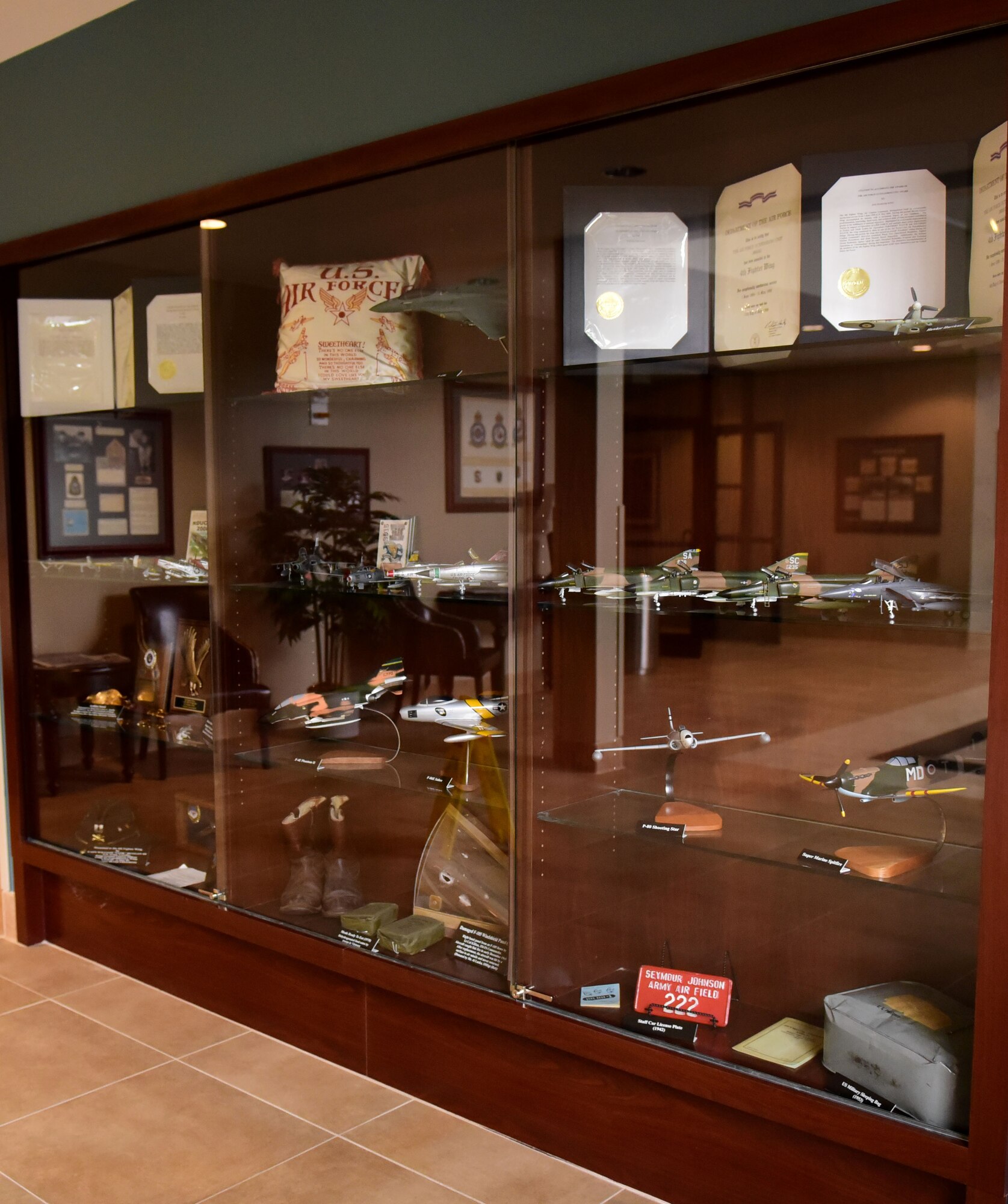 A display case filled with memorabilia and recently added model aircraft was dedicated, in the 4th Mission Support Group building, Sept. 27, 2017, at Seymour Johnson Air Force Base, North Carolina.