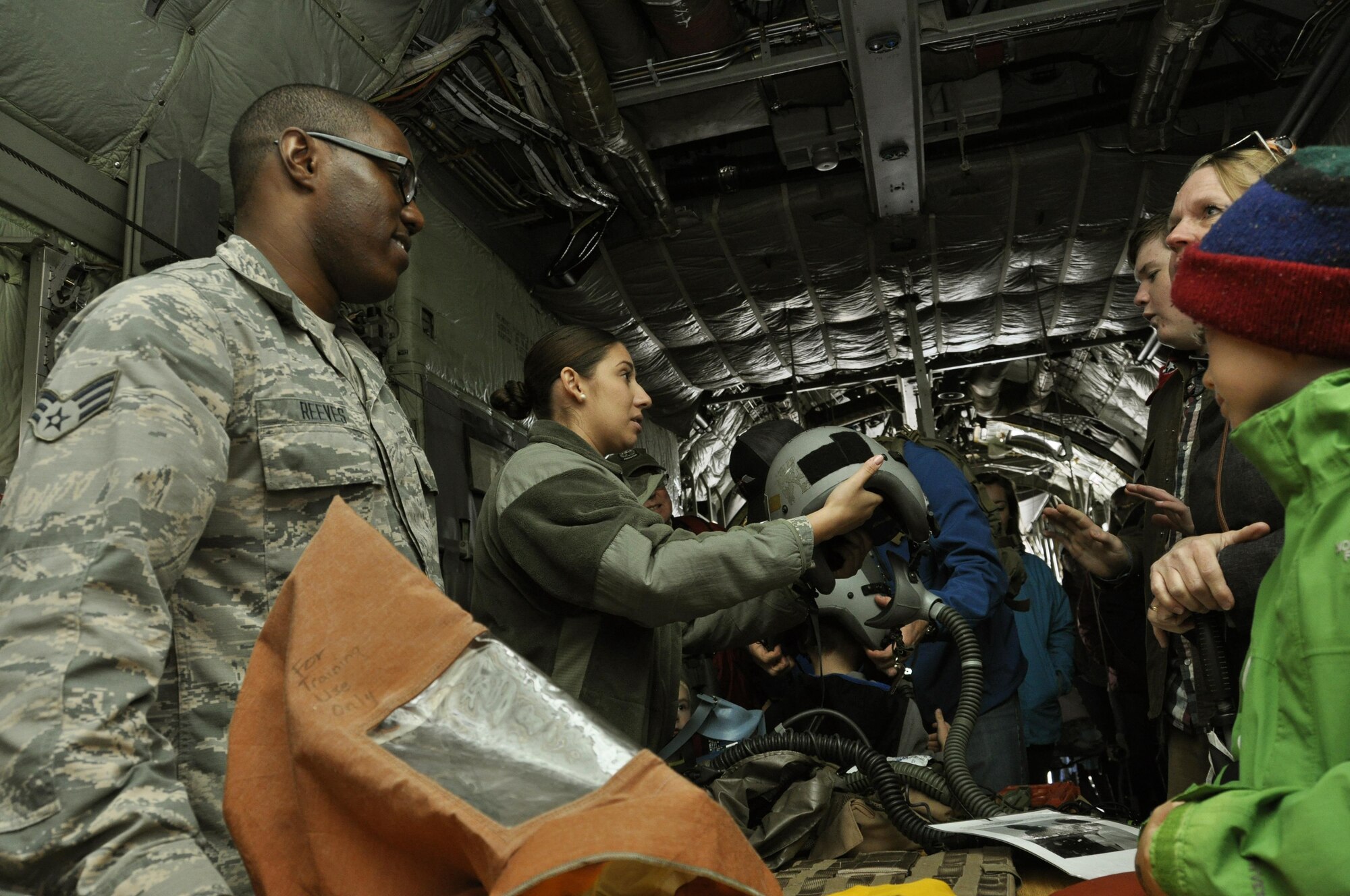 Senior Airmen Rickey Reeves and Marianela Valdez Ruano, 302nd Operations Support Squadron, explain the use of aircrew flight equipment to Pikes Peak Regional Airshow attendees Sept. 24, 2017, at the Colorado Springs Airport, Colo.