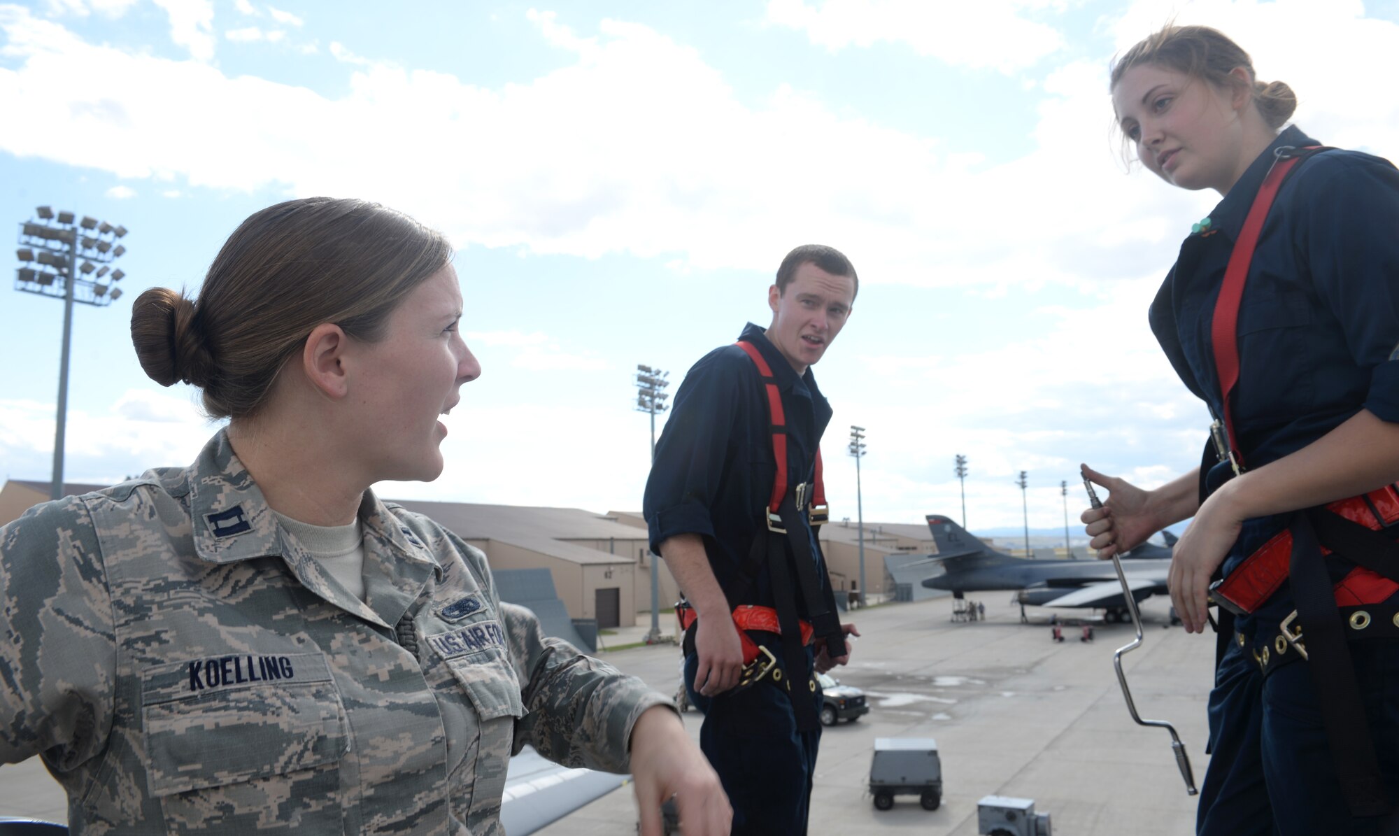 Capt. Lacey Koelling, officer in charge of the 34th Aircraft Maintenance Unit, talks to Airmen 1st Class Preston Schroeder and Kristy Urban, electro environmental systems specialists assigned to the 28th Aircraft Maintenance Squadron, at Ellsworth Air Force Base, S.D., Sept. 26, 2017. Koelling likes to engage with her Airmen on the flightline and see what her Airmen are working on. (U.S. Air Force photo by Airman 1st Class Thomas Karol)