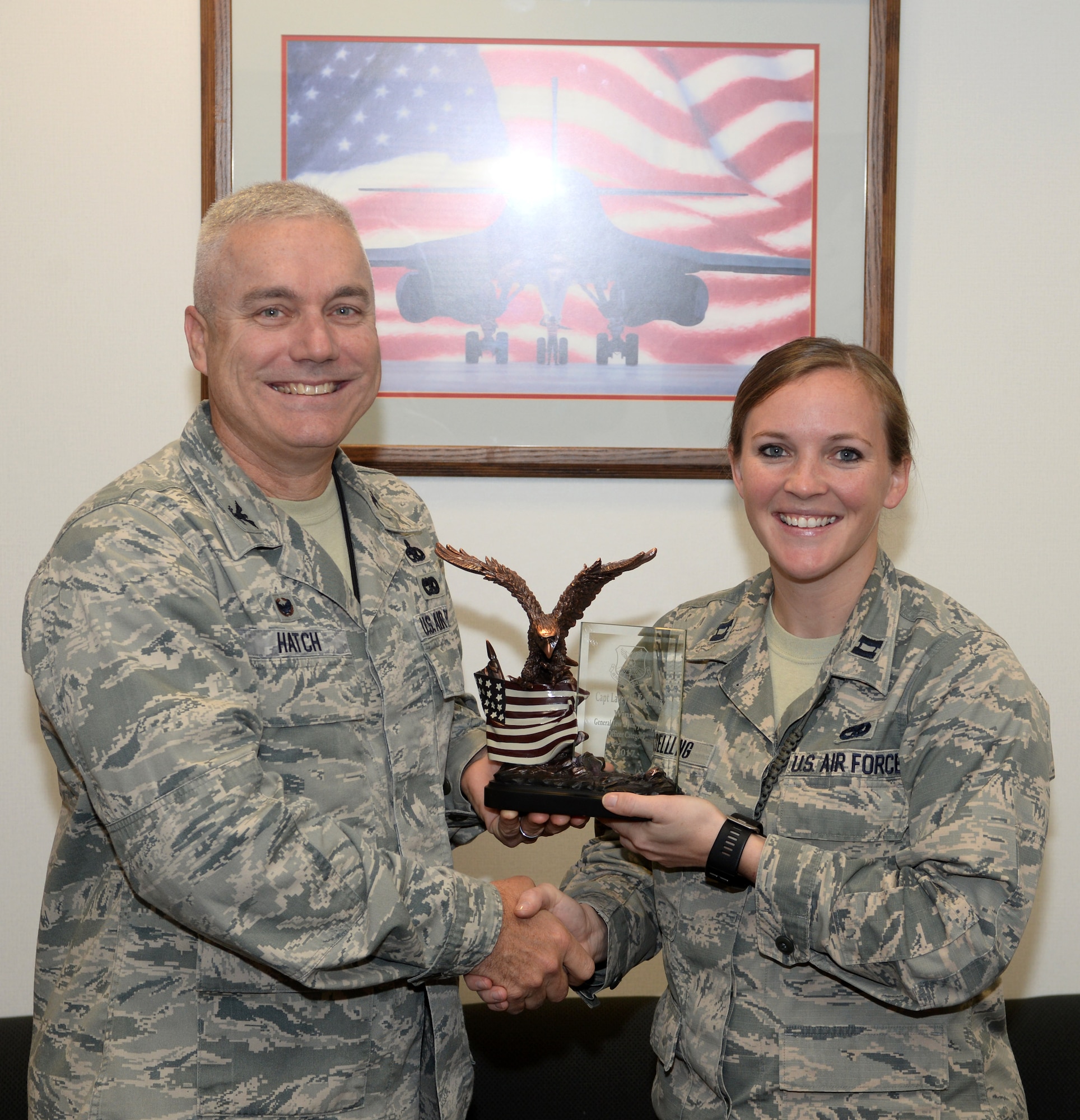 Capt. Lacey Koelling, officer in charge of the 34th Aircraft Maintenance Unit, and Col. Bernard J. Hatch III, the commander of the 28th Maintenance Group, hold the General Lew Allen, Jr., Trophy which was presented to Koelling at Ellsworth Air Force Base, S.D., Sept. 26, 2017. Koelling earned the award for her actions during her deployment to Al-Dhafra Air Base in the United Arab Emirates. (U.S. Air Force photo by Airman 1st Class Thomas Karol)
