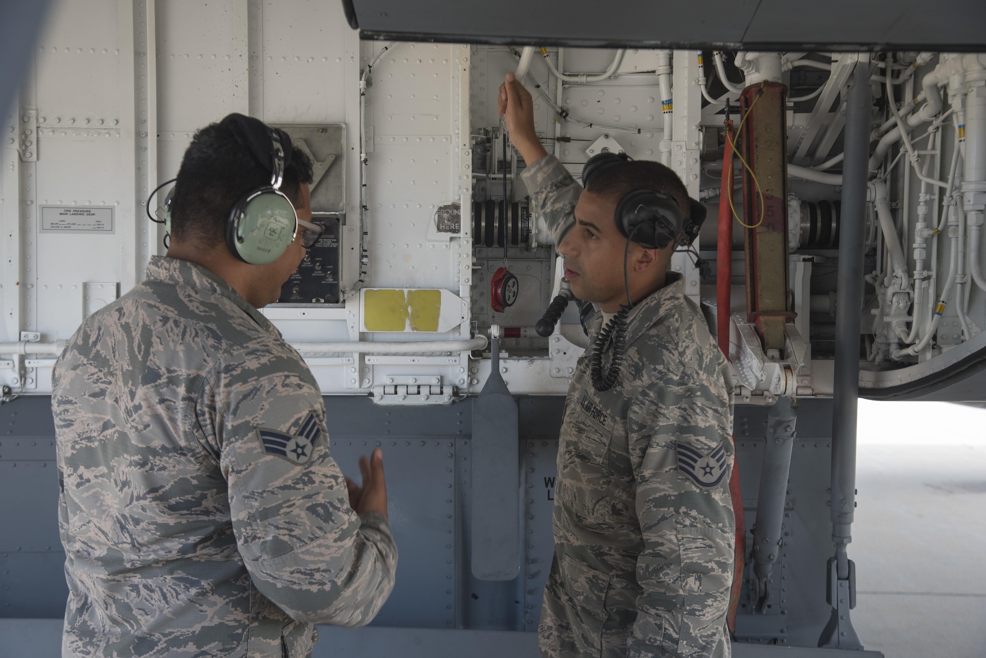 Senior Airman Jonathan Palascios-Conde, crew chief (left), discuss proper procedures for refueling with Staff Sergeant Jonathan Carmona, crew chief (right), while refueling a KC-135 on the 108th Wing tarmac at Joint Base McGuire-Dix-Lakehurst, N.J. Sept. 20, 2017. (U.S. Air National Guard photo by Staff Sgt. Ross A. Whitley/Released)