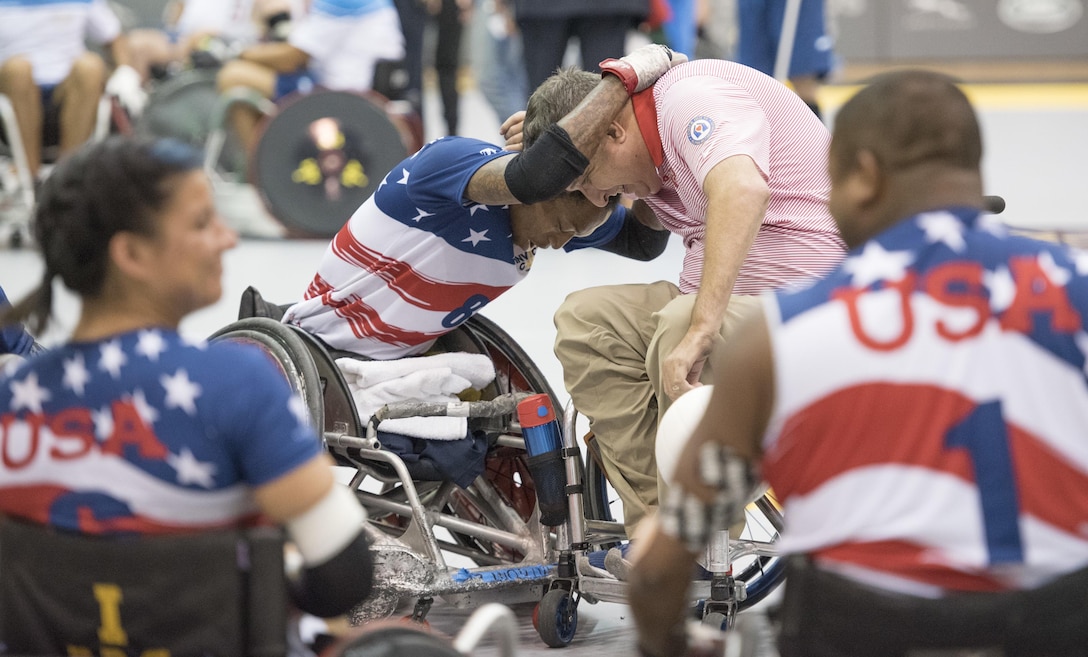 Anthony McDaniel, a Marine Corps veteran, hugs head coach James Humbert after the U.S. team won a wheelchair rugby game against Italy during the 2017 Invictus Games