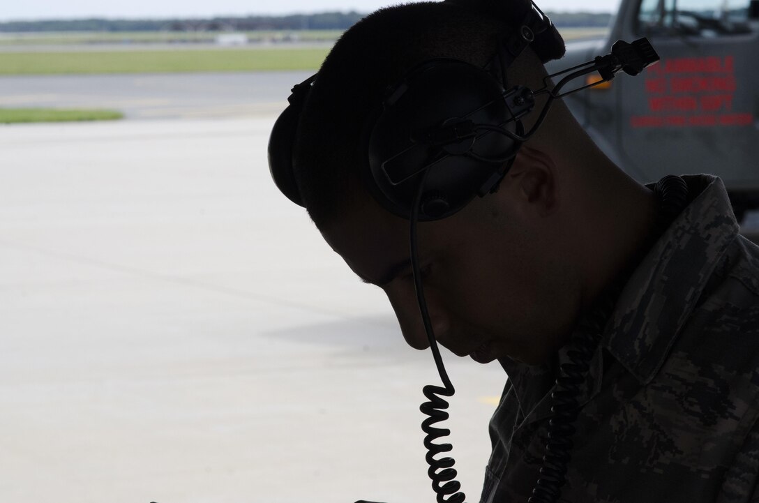 Silhoutte of Staff Sergeant Jonathan Carmona, crew chief, reviewing a technical order on the 108th Wing apron at Joint Base McGuire-Dix-Lakehurst, N.J., Sept. 20, 2017. (U.S. Air National Guard photo by Staff Sgt. Ross A. Whitley/Released)