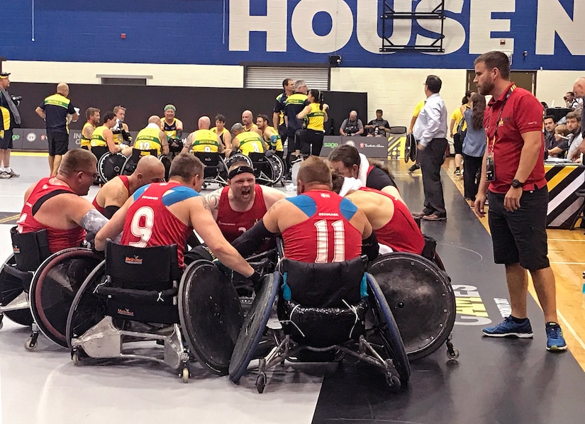 Danish team captain army Cpl. Mark Peters leads Denmark’s rugby team in a victory cheer