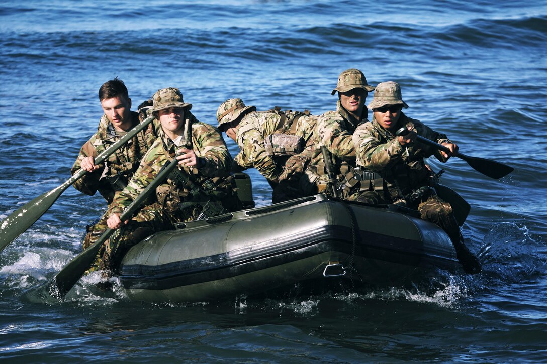 Soldiers paddle towards shore during sea insertion training.