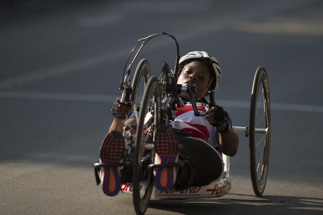 Sharona Young, a medically retired Navy chief petty officer, races a hand cycle during the 2017 Invictus Games