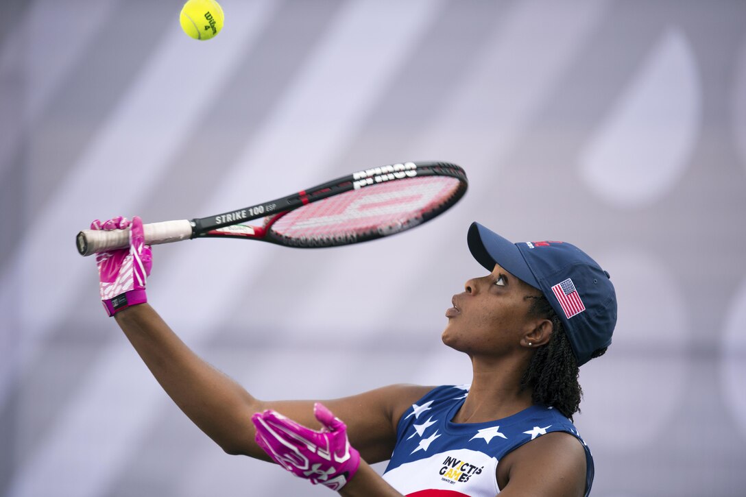 Sharona Young, a medically retired Navy chief petty officer, serves during tennis preliminaries at the 2017 Invictus Games