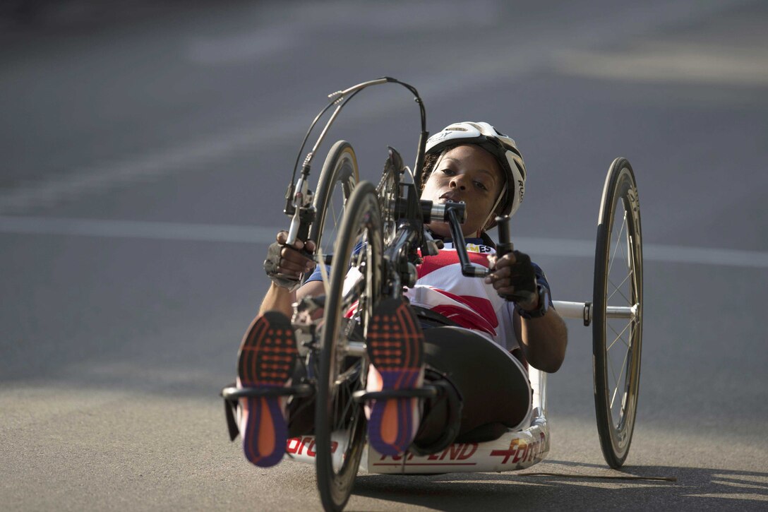 An athlete races a hand cycle.