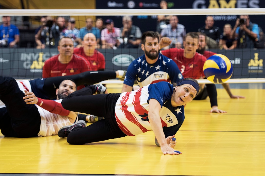 U.S. Army veteran Randi Hobson dives for a ball during the bronze medal match against the Danes in sitting volleyball.