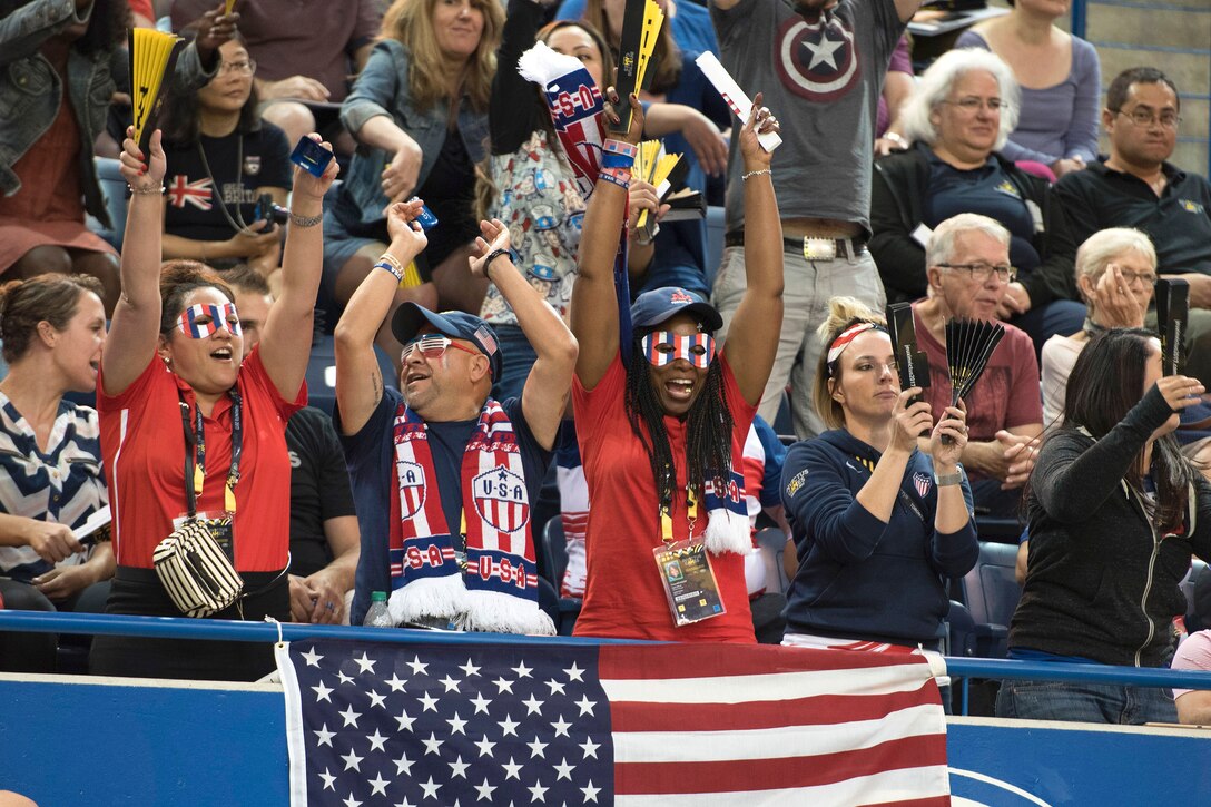 Family members and supporters cheer for the U.S. during the bronze medal match against Denmark in sitting volleyball.